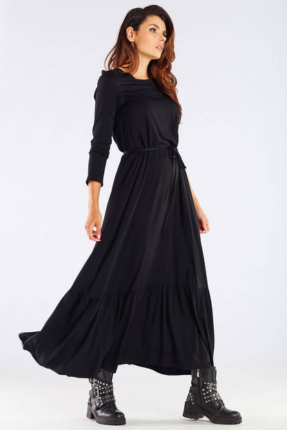 Model gracefully wearing the Luxurious Viscose Kimono Cut Day Dress with Frill and Belt by Awama in black, accentuating the dress's long, elegant silhouette.