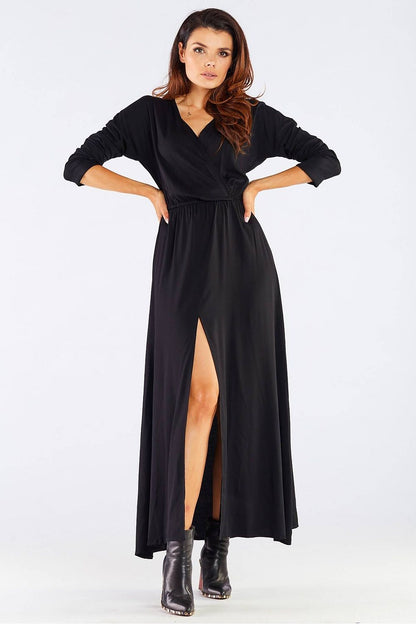 Elegant Long Sleeve Daydress in Viscose with Zip Detail - Perfect for Colder Days, illustrated by a model in a stunning black dress featuring a front view highlighting its feminine silhouette and stylish slit.