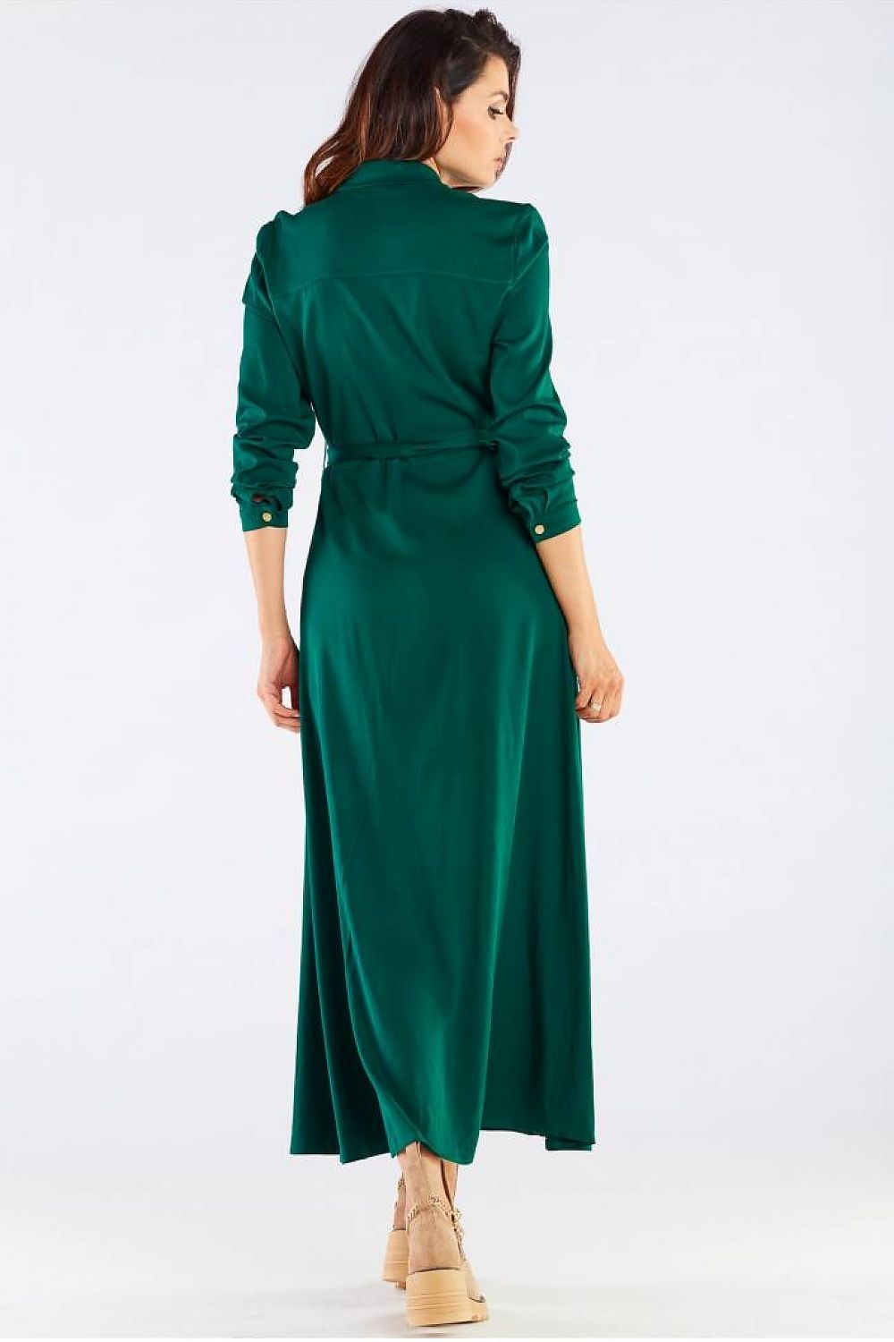 Back view of the stunning maxi dress with buttoned trapeze bottom and collared belt, exhibiting the flowing silhouette on the model, accented by the lush green fabric.