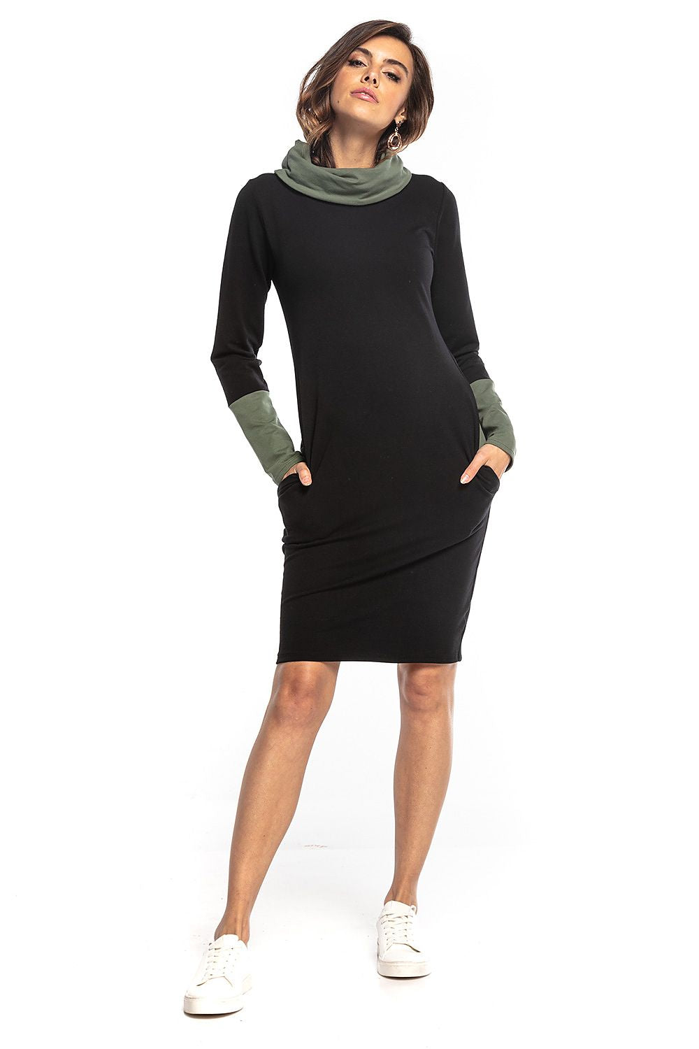 Chic fitted Tessita daydress with a soft turtleneck and stylish green contrasting sleeves, embodying everyday luxury.