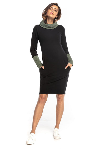 Chic fitted Tessita daydress with a soft turtleneck and stylish green contrasting sleeves, embodying everyday luxury.