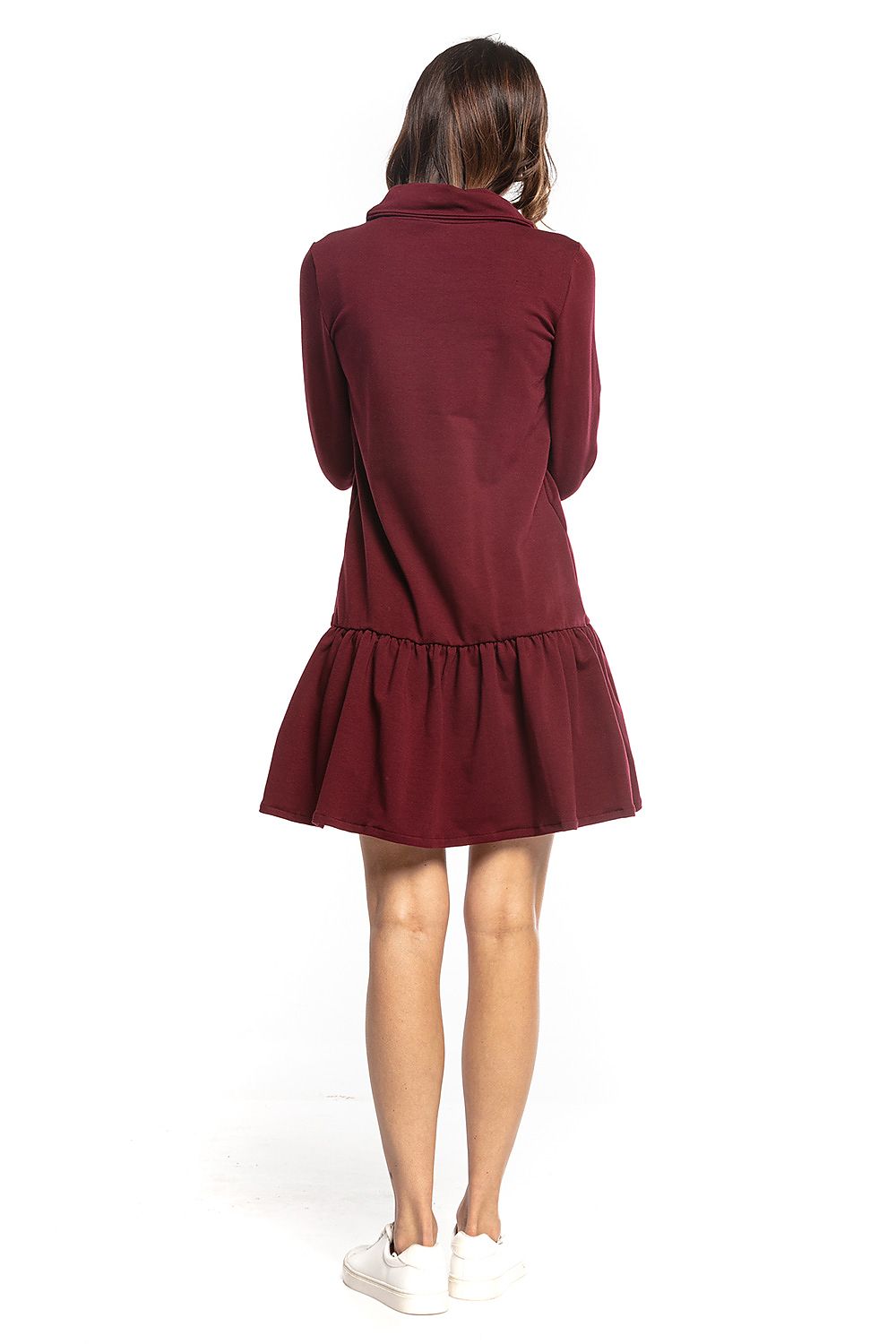 Back view of the luxurious burgundy Tessita sporty midi dress with turtleneck and frill hem, paired perfectly with classic white sneakers.