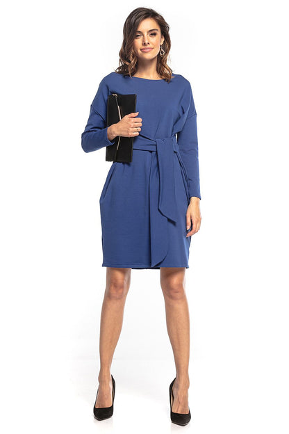 Chic blue midi dress by Tessita designed in a kimono style with a tie belt, complemented by elegant accessories for a modern luxury look.