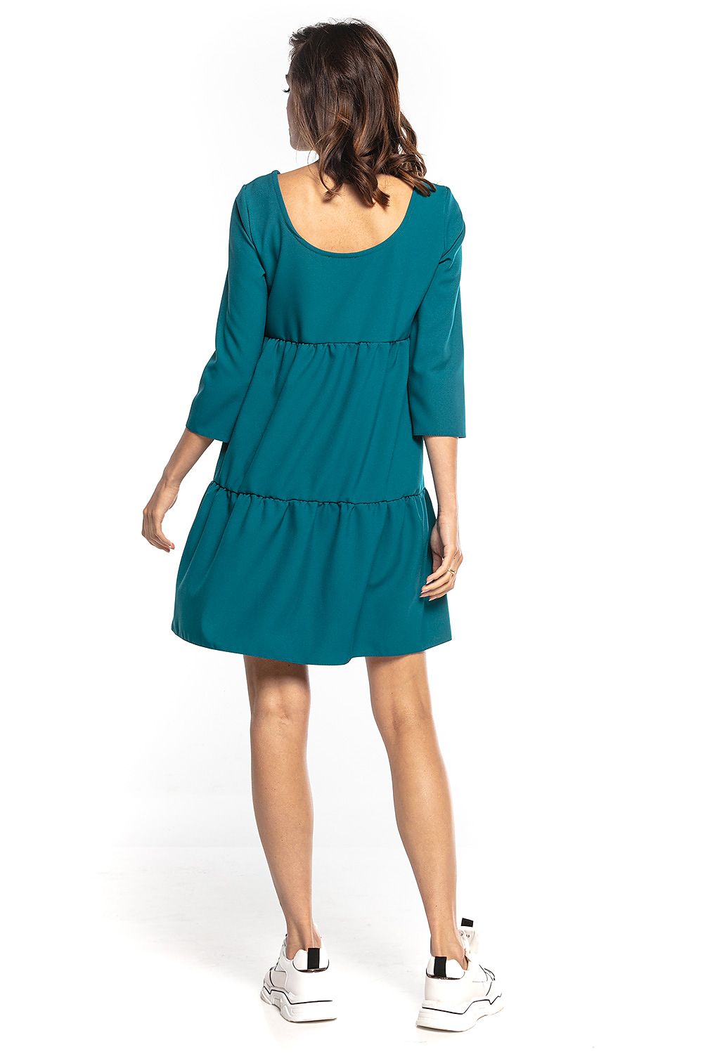 Elegant teal mini dress with 3/4 sleeves and a deep back neckline, designed by Tessita. Features a flared cut adorned with ruffles, embodying sophistication and comfort.