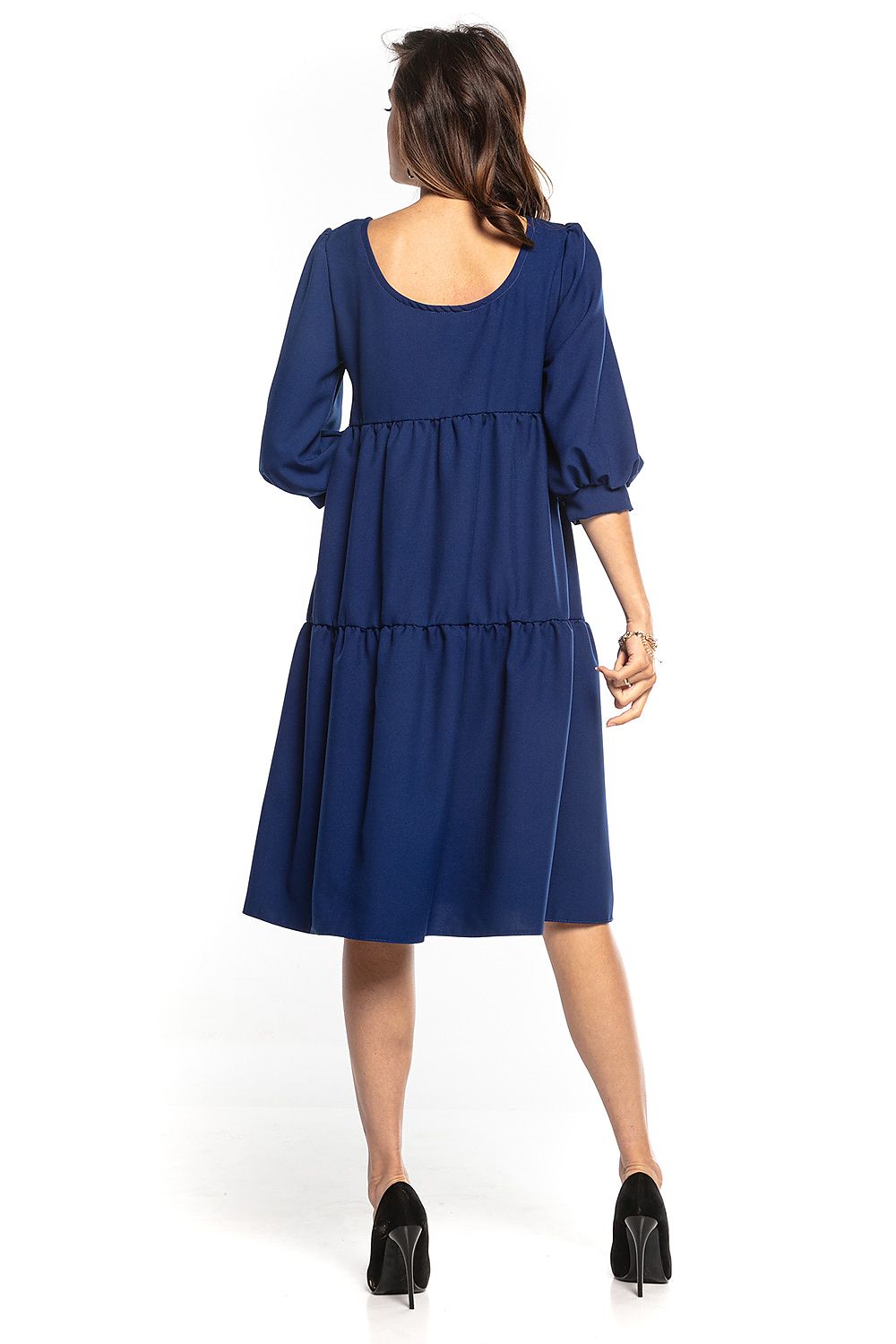 Back view of a luxury navy blue bouffant sleeve day dress with ruffles and flared design, tailored by Tessita.