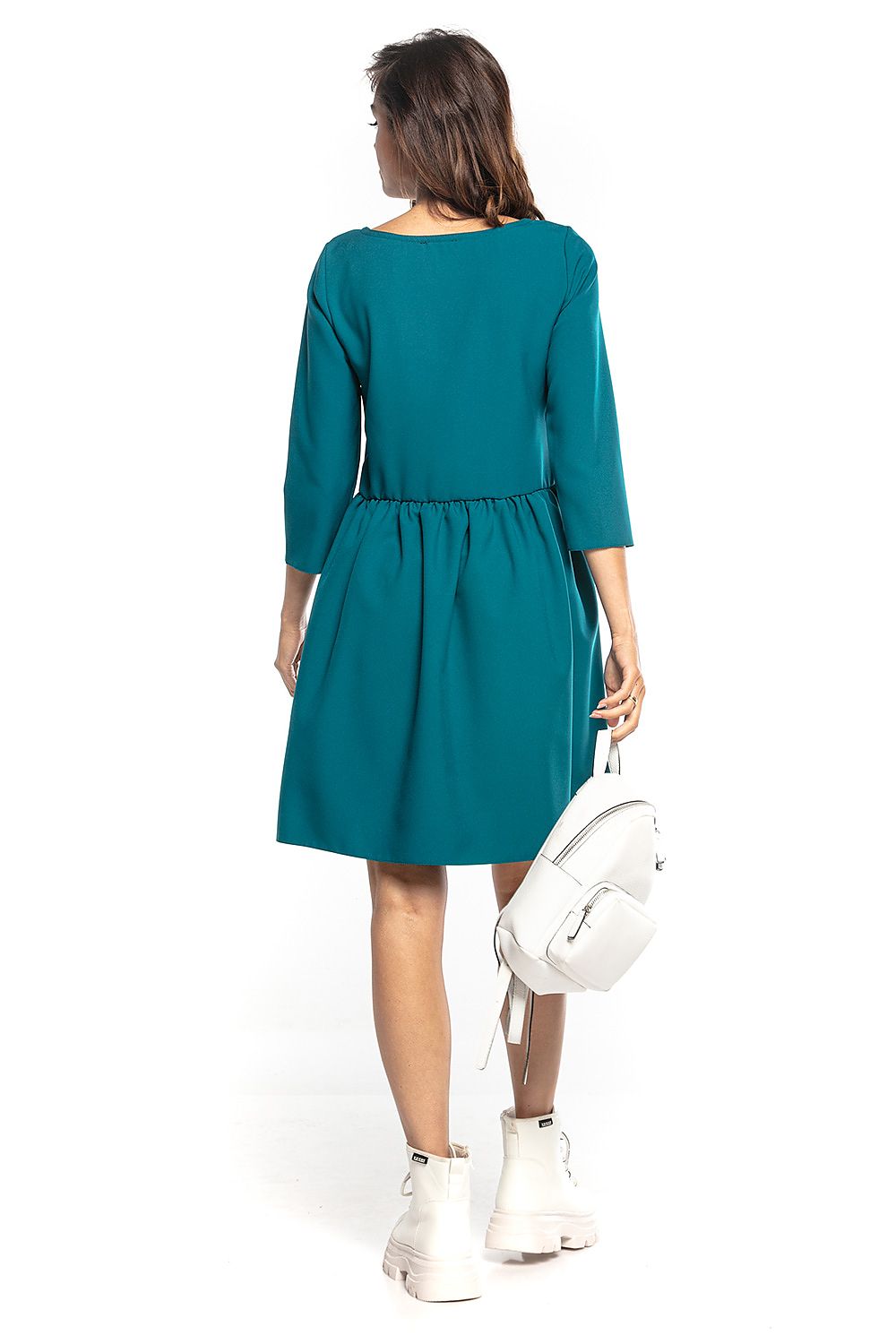 Elegant midi dress with 3/4 sleeves and waist pleats in teal, styled with a fashionable backpack, by Tessita.