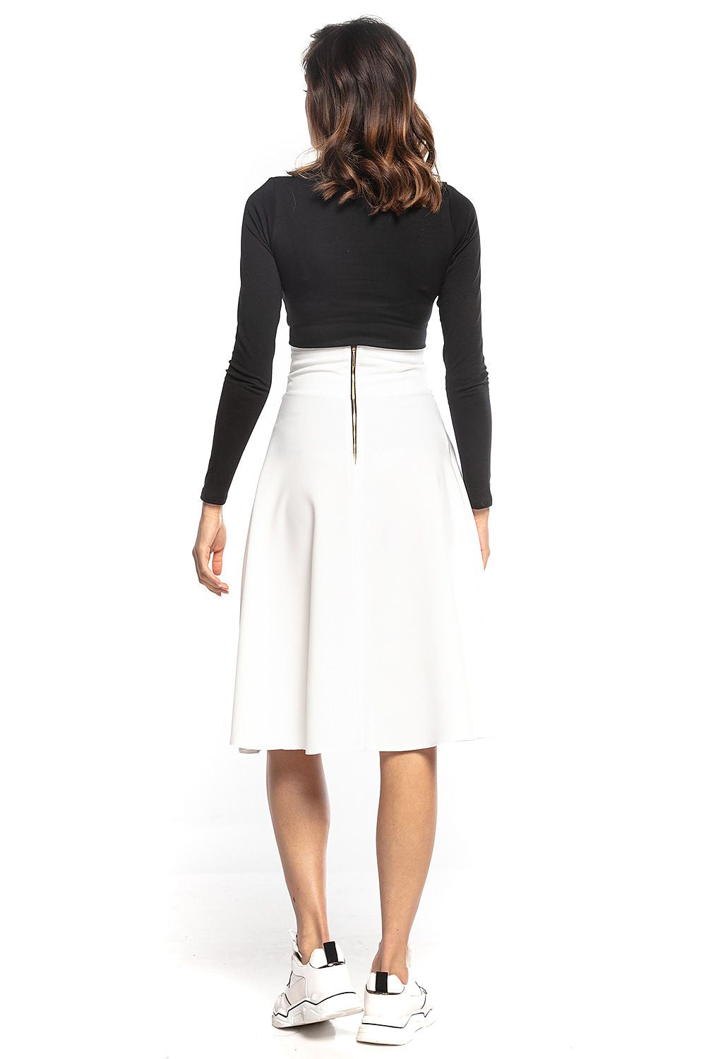 Back view of the sophisticated Tessita luxury midi skirt in white, showcasing the decorative zipper and high waist design, paired with a black fitted top.