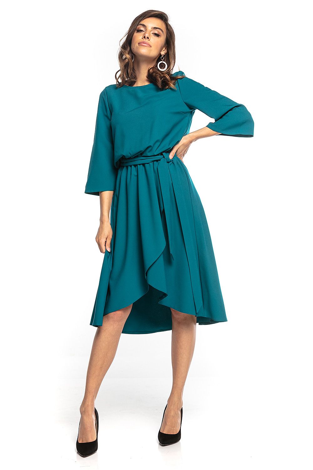 Elegant asymmetrical midi dress with 3/4 sleeves and waist belt by Tessita, showcased in a stunning turquoise shade, perfect for sophisticated occasions.