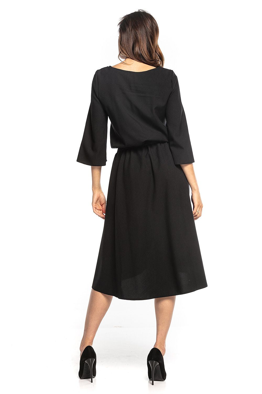 Rear view of the sophisticated asymmetrical midi dress with 3/4 sleeves by Tessita, highlighting the elegant flowing fabric and flattering fit.