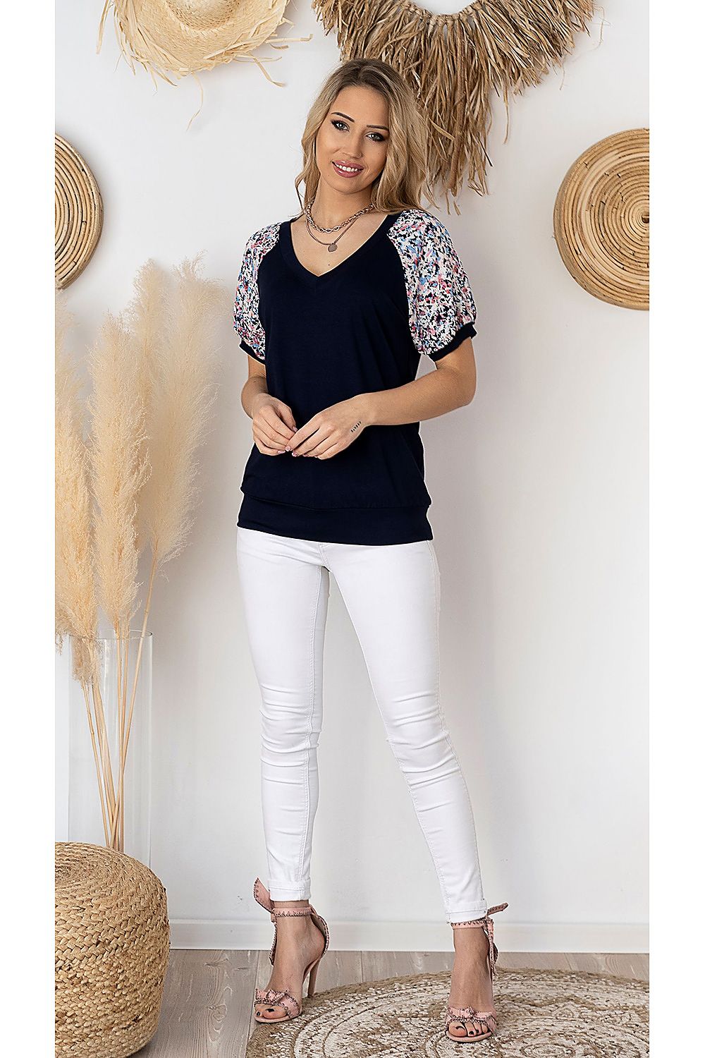 Stylish full-body view of a navy blue Hajdan blouse with floral printed accents, paired with white slim-fit jeans, perfect for a sophisticated, casual look.