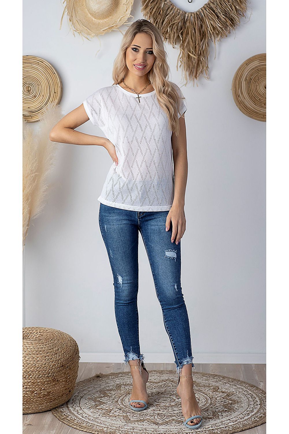 Chic sleeveless blouse by Hajdan showcased in a stylish setting, worn by a woman with long blonde hair, complemented by distressed denim jeans, ideal for a trendy summer look.