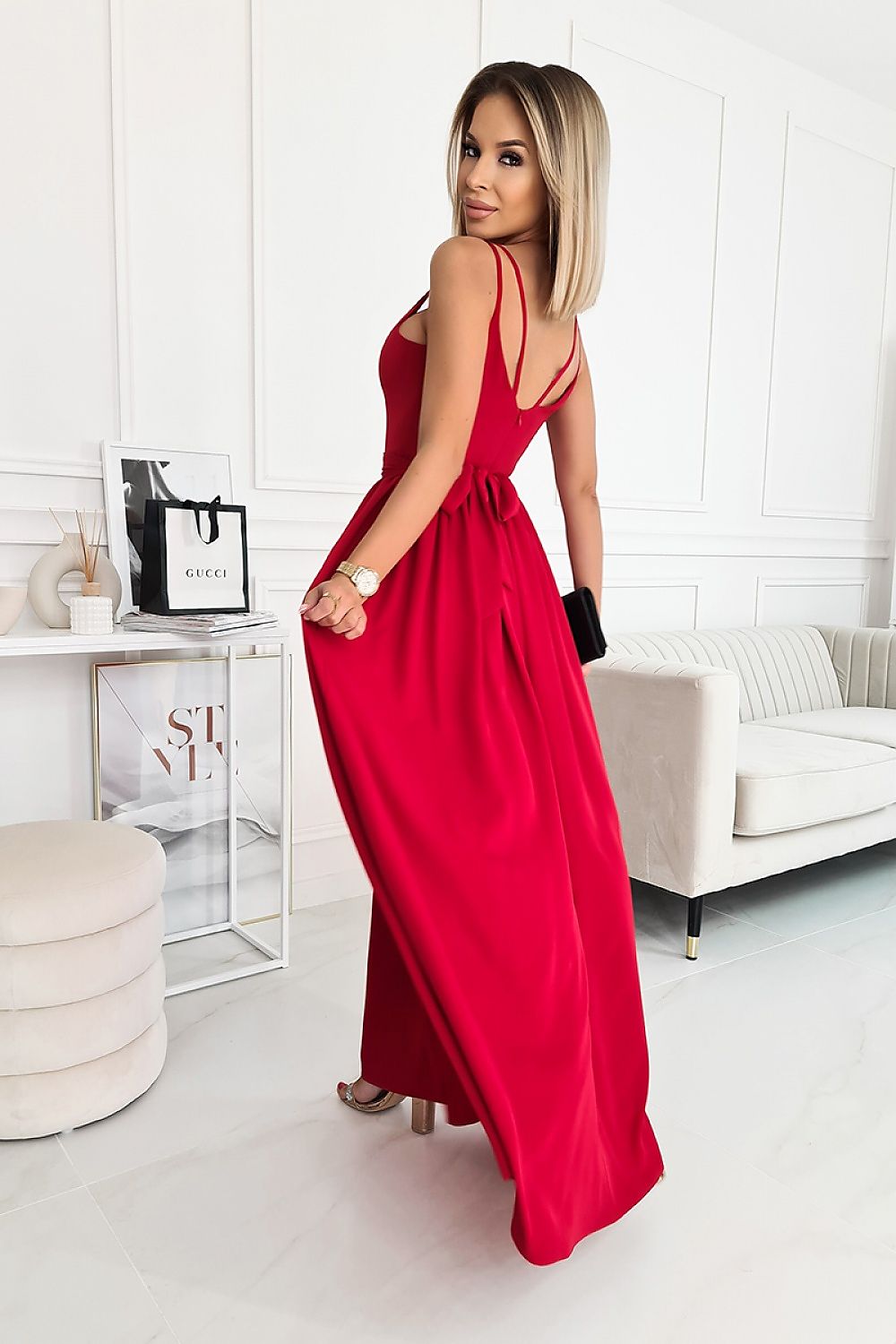 Back view of an exquisite long dress by Bicotone in red, highlighting its elegant silhouette and delicate straps, perfect for a glamorous look.