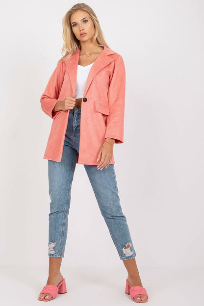 Chic model showcases a luxurious coral imitation suede jacket styled with light blue jeans and stylish pink heels, perfect for any fashionable occasion.