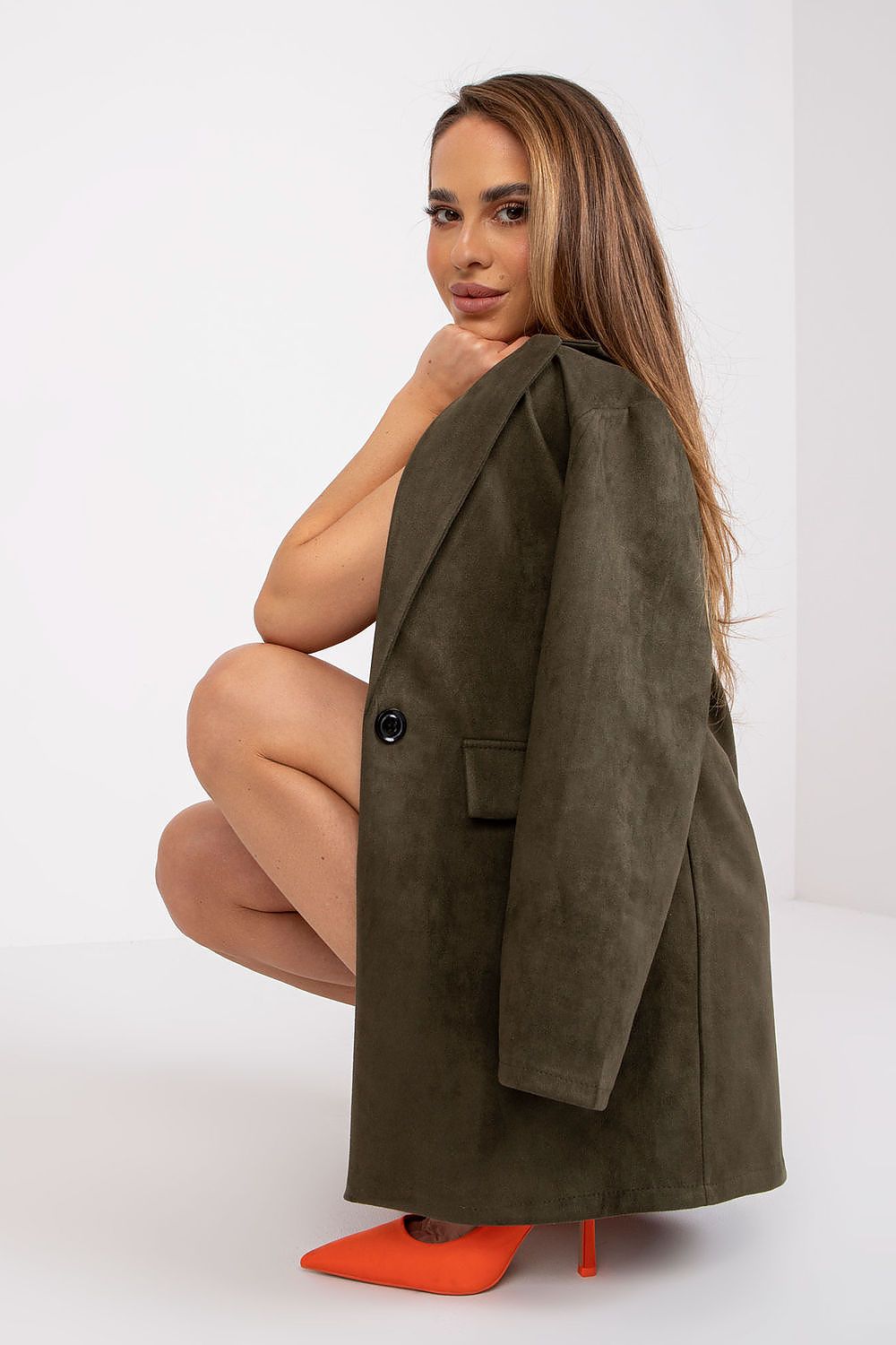 Fashion-focused image featuring a model in an olive green Luxury Imitation Suede Jacket by Italy Moda, accentuated with striking orange heels, exuding contemporary elegance.