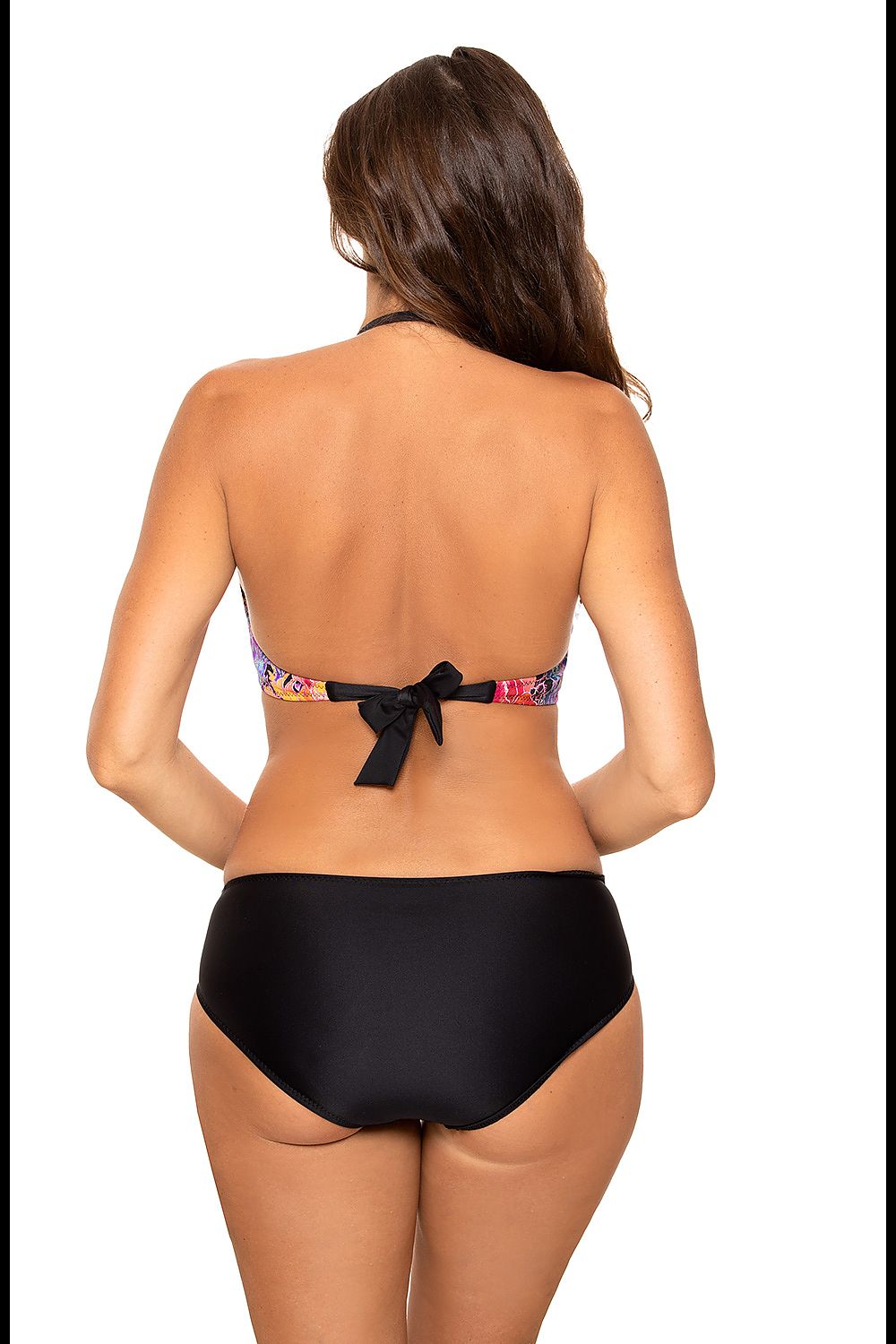 Chic woman wearing a stylish two-piece swimsuit by Marko, displaying the intricate design and back tie detail, with a tropical vibe.