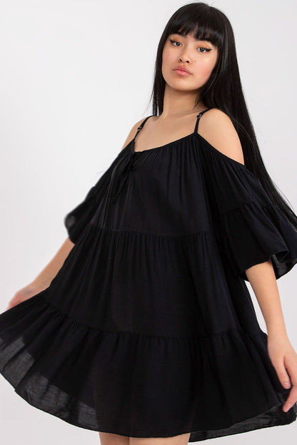 Elegant black summer dress by Och Bella featuring an asymmetrical cut, frills, and 3/4 sleeves, perfect for stylish and sophisticated occasions.