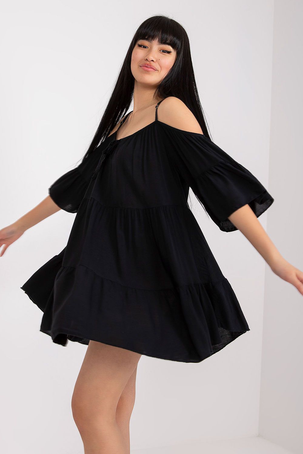 Elegant black summer dress featuring an asymmetrical cut, frills, and 3/4 sleeves, perfect for stylish casual outings.