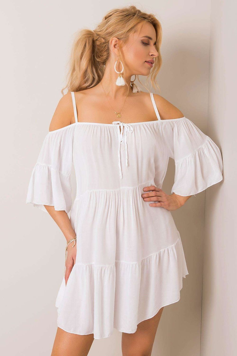 Stunning white summer dress featuring a stylish off-shoulder neckline and frill accents, exuding luxury for any sunny occasion.