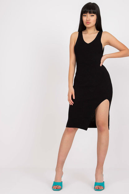 Elegant black fitted pencil dress by Och Bella featuring stylish shoulder straps and a daring thigh-high slit, perfect for sophisticated occasions.