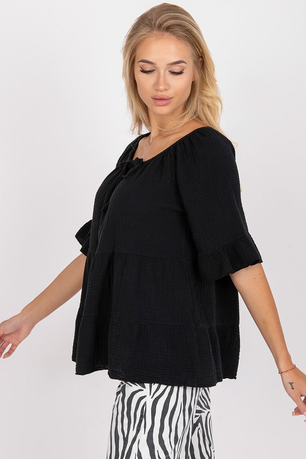 Chic black cotton blouse with ruffled sleeves and a tied neckline, showcasing a relaxed fit, perfect for casual luxury attire.