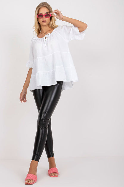 Elegant model showcasing the Och Bella Loose Fit Cotton Blouse with ruffled sleeves, styled with sleek black leggings and chic pink accessories for a casual yet sophisticated look.