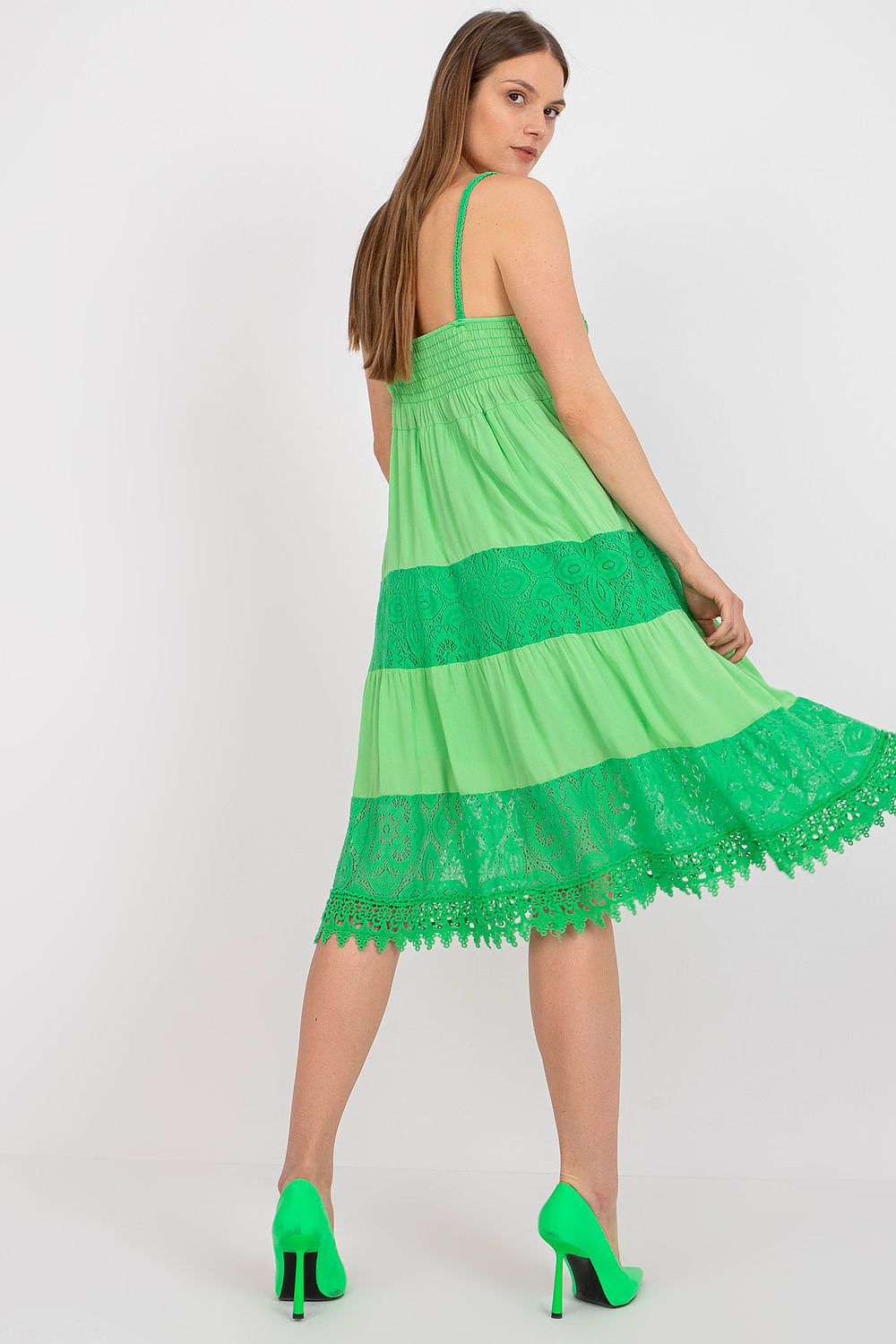 Chic back view of the Och Bella summer flared dress in lush green, showcasing its stylish openwork lace hem and a comfortable elasticated bodice, exuding luxury and comfort.