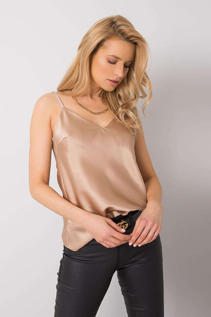 Chic luxury adjustable strap T-shirt by Och Bella in soft beige, featuring a flattering neckline and styled with fitted black trousers, ideal for a modern summer look.