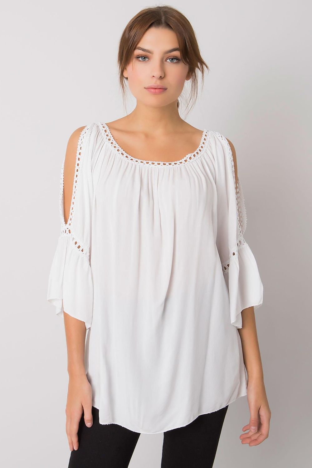 Chic white loose-fit blouse with 3/4 sleeves and stylish open shoulder design, elegantly enhanced with decorative slit details on the sleeves.