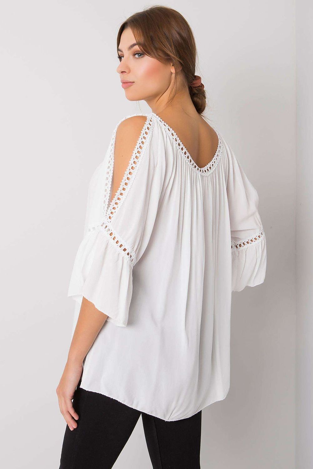 Refined back view of a sophisticated white loose-fit blouse with stylish open shoulders, featuring delicate stitching and generous drape, perfect for casual elegance.