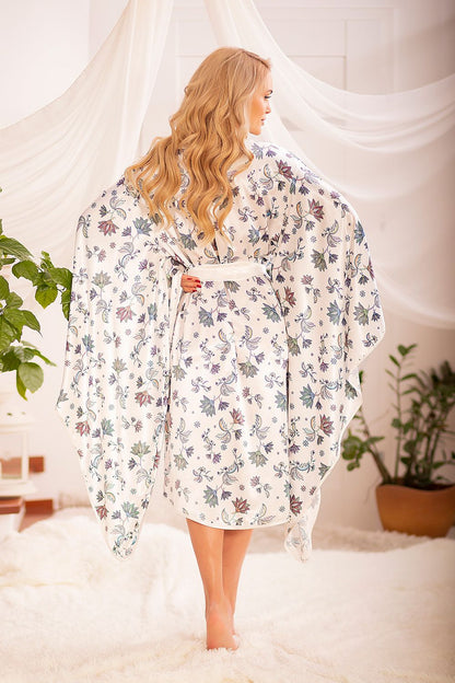 Back view of a model in a Kalimo satin chemise bathrobe with wide sleeves and floral patterns, highlighting the robe's luxurious design and perfect fit for elegant loungewear.