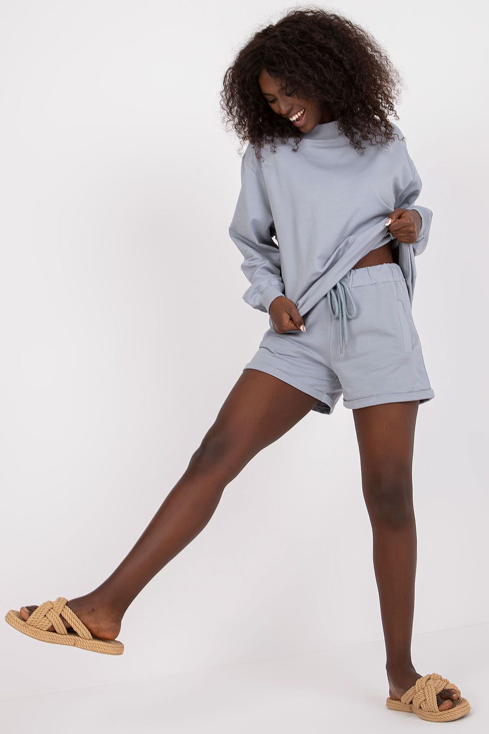 Elegantly styled BFG men's luxury cotton sweatshorts featured in soft blue, paired with a matching oversized top, perfect for summer leisure wear.