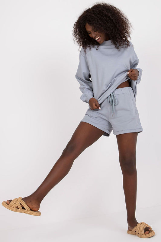 Elegantly styled BFG men's luxury cotton sweatshorts featured in soft blue, paired with a matching oversized top, perfect for summer leisure wear.