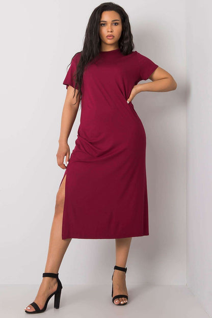 Refined plus size summer dress in burgundy by BFG, featuring a flattering silhouette and stylish slits, model showcases a confident pose in high heels, ideal for summer events.