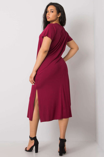 Elegant plus size summer dress with short sleeves featuring stylish slits, showcased on a model against a neutral backdrop. Ideal for versatile summer wear, highlighting a chic and luxurious look.