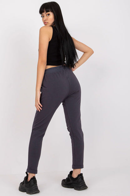 Elegant model showcasing luxury high-waist BFG tracksuit trousers in dark grey, featuring a snug fit and stylish slip pockets, perfect for a chic casual look.