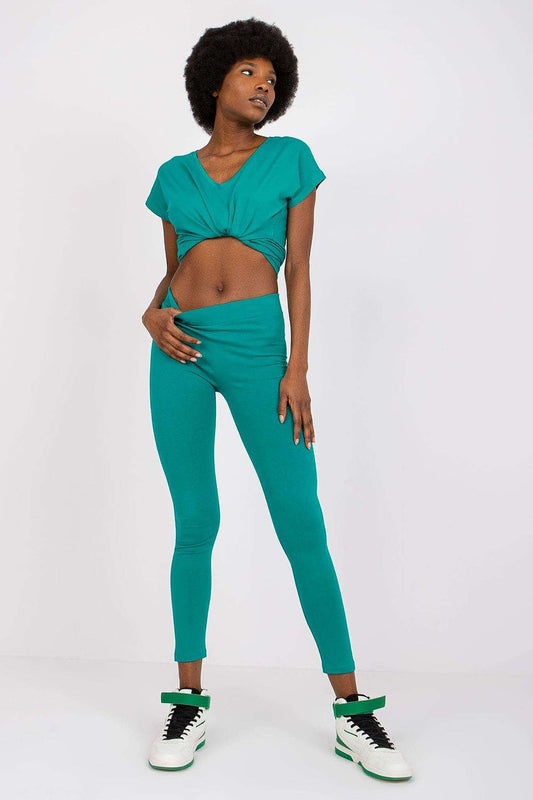 Elegant model showcasing BFG Luxury Cotton-Spandex Leggings in striking teal, paired with a matching cropped top, exuding a chic and stylish vibe with a fitted design.