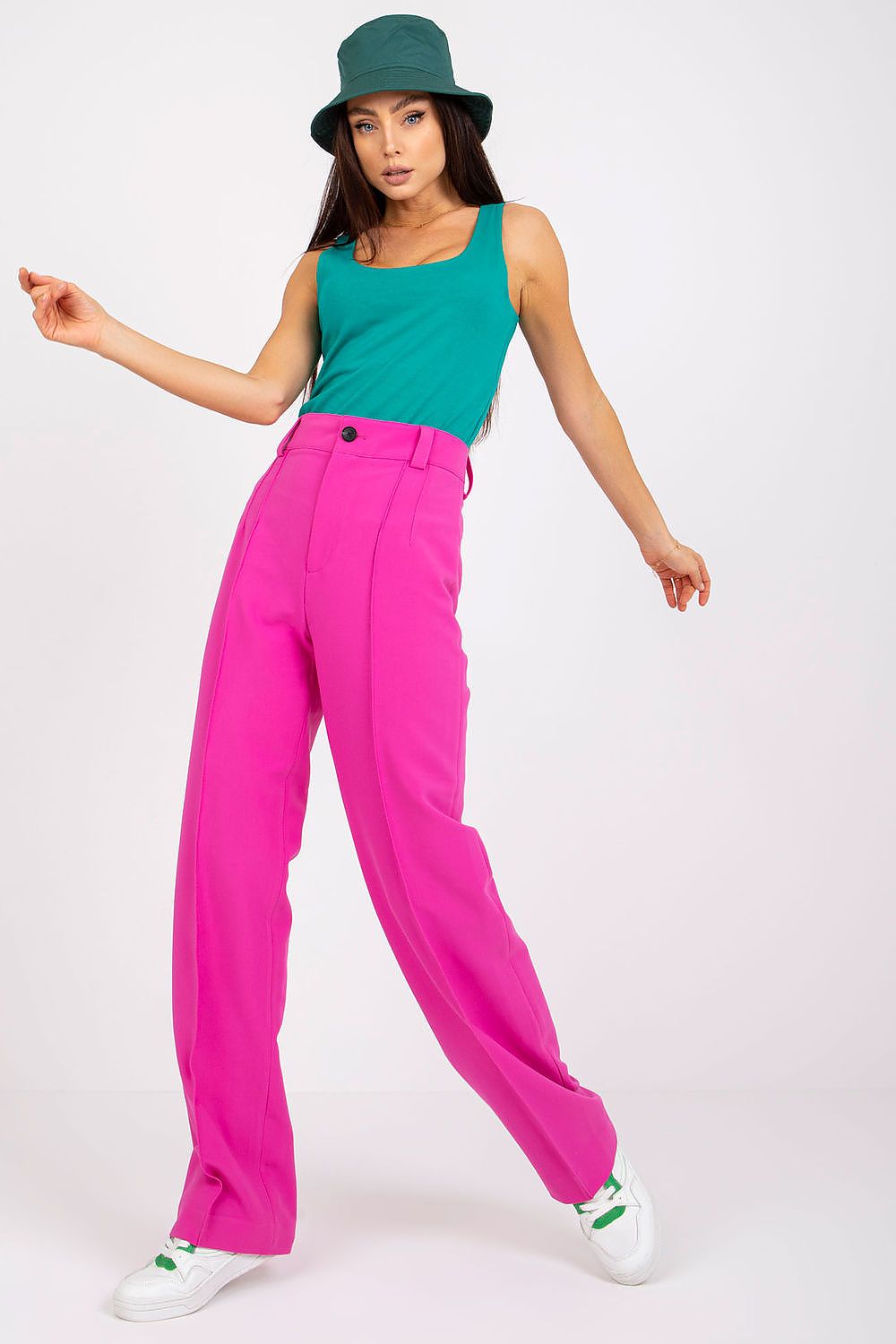 Stylish model wearing an Elegant Strapless T-Shirt in Premium Cotton & Spandex Blend, paired with vibrant pink high-waisted trousers and a chic green bucket hat, embodying effortless summer style.