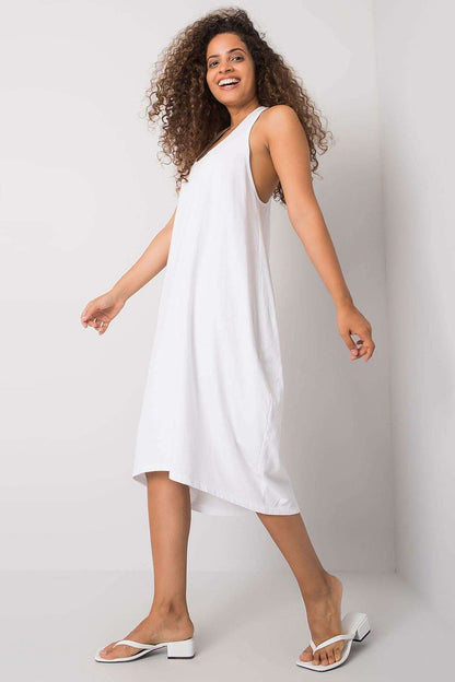 Model moving gracefully in the Och Bella Sleeveless Cotton Spandex Daydress in white, demonstrating its flattering silhouette and versatility for casual occasions.
