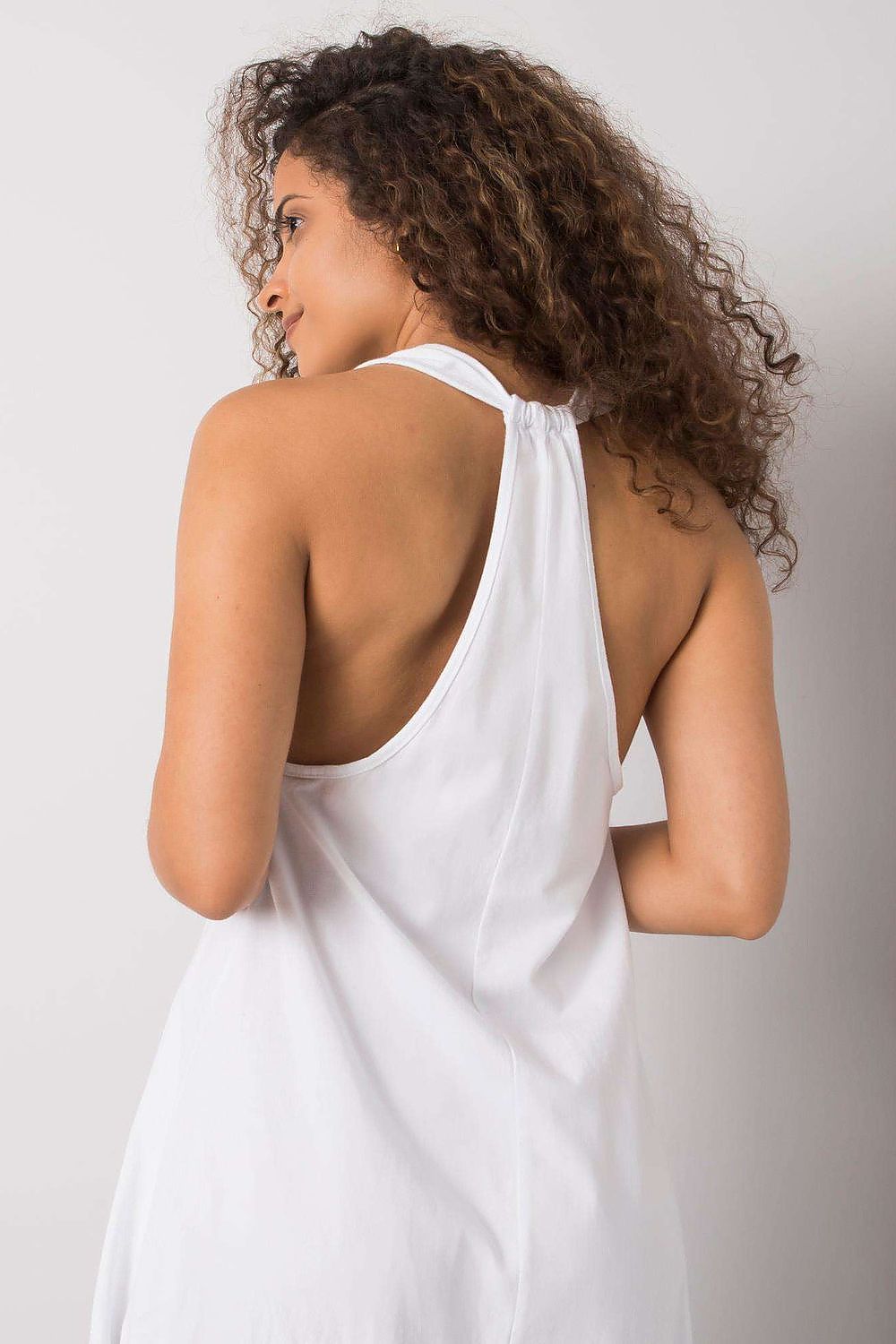 Close-up of the back view of a model wearing the white Och Bella Sleeveless Cotton Spandex Daydress, showcasing its elegant design and breathable fabric.