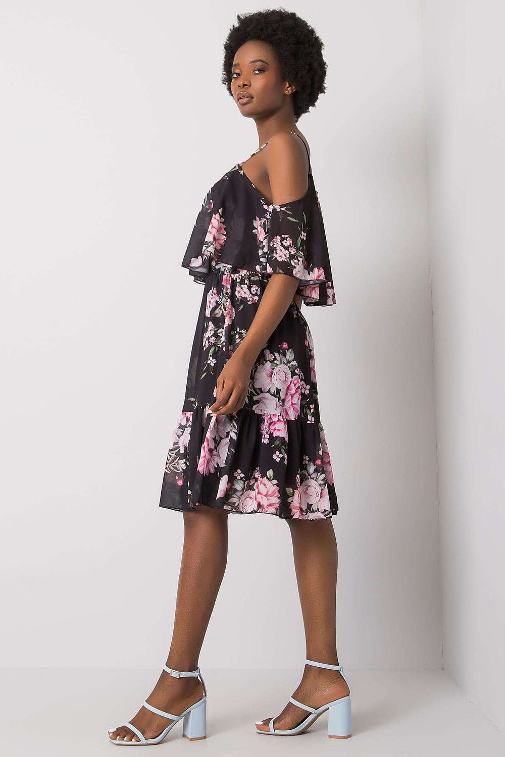 Och Bella Floral Strapless Daydress with Frill - Elegant Flared Cut model wearing the dress with a striking black backdrop, showcasing vibrant floral patterns.