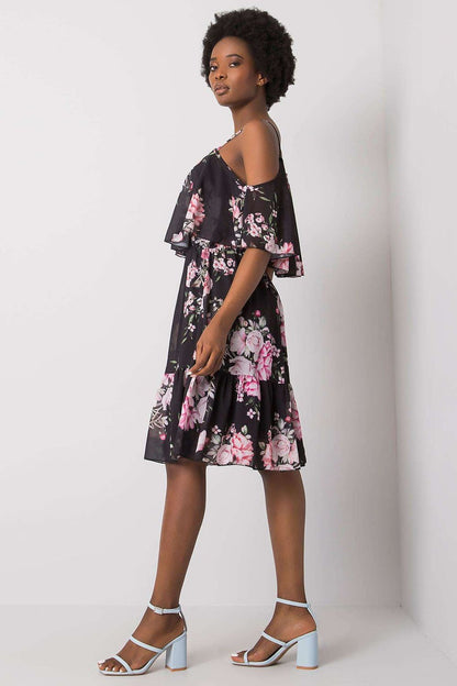 Och Bella Floral Strapless Daydress with Frill - Elegant Flared Cut model wearing the dress with a striking black backdrop, showcasing vibrant floral patterns.