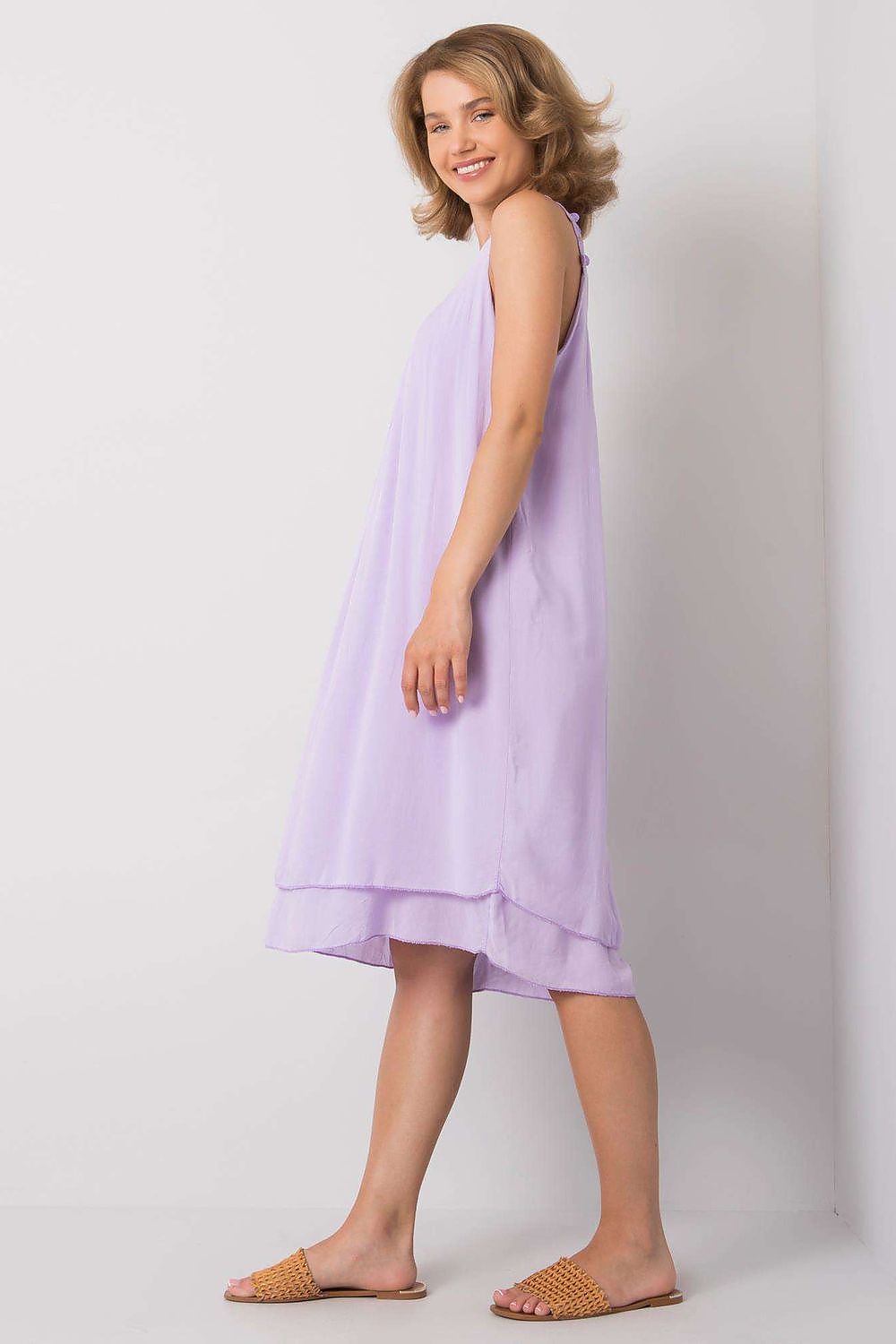 Elegantly Designed Summer Dress With Decorative Straps By Och Bella - Side view of a model wearing a lavender summer dress, highlighting its flowing silhouette and versatile design.