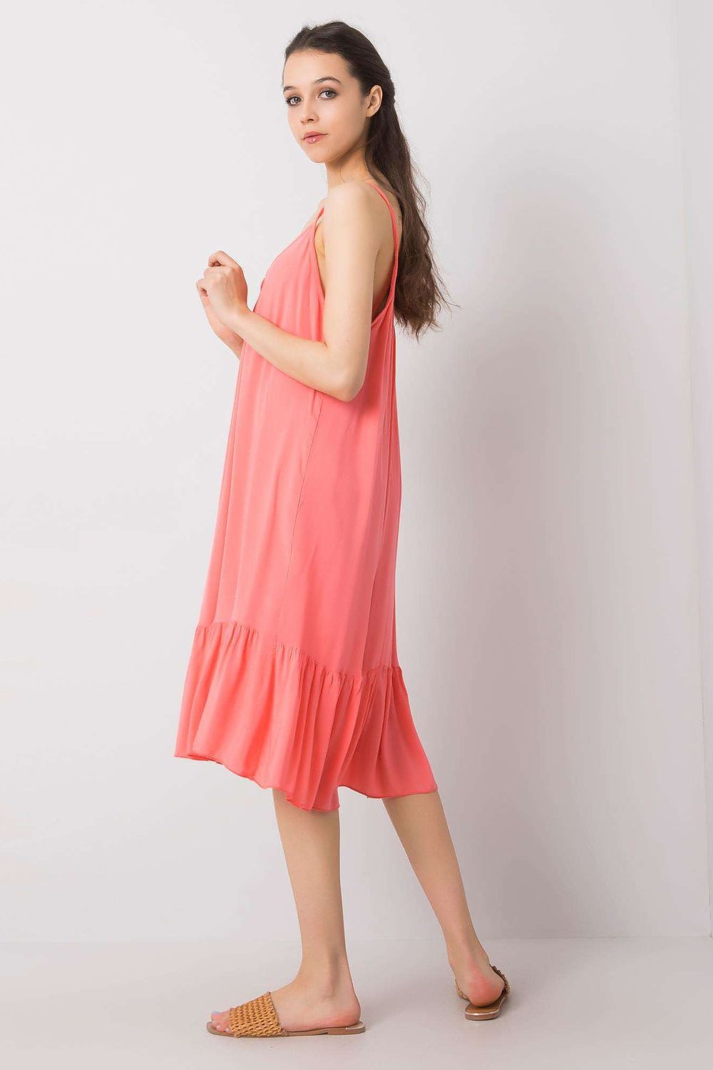 Elegant side view of the strapless flared daydress with frill by Och Bella, highlighting its flowing design and luxurious coral hue for summer sophistication.