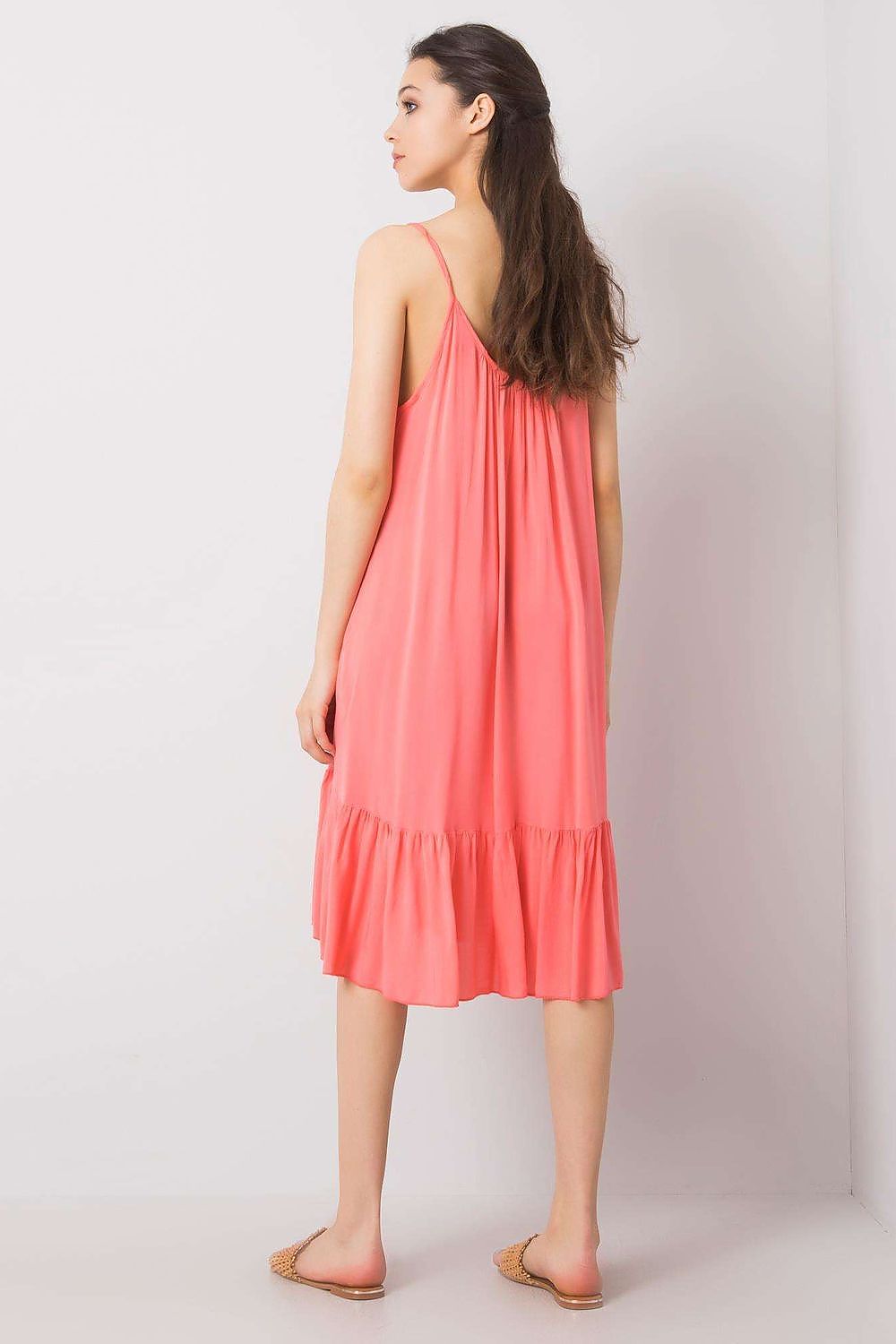 Back view of the strapless flared daydress with frill by Och Bella, emphasising the dress’s relaxed fit and exquisite summer charm in coral.