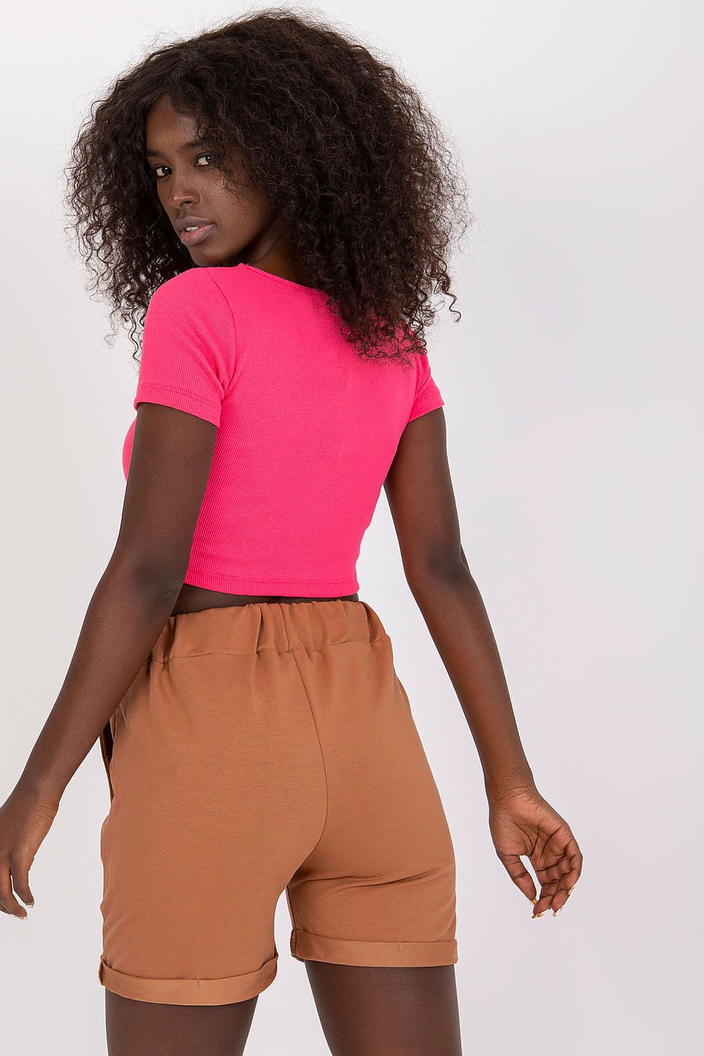 Back view of luxury cotton high-waisted shorts with tie waist and pockets, paired with a pink crop top, showcasing a chic and stylish design. EU Size 0.
