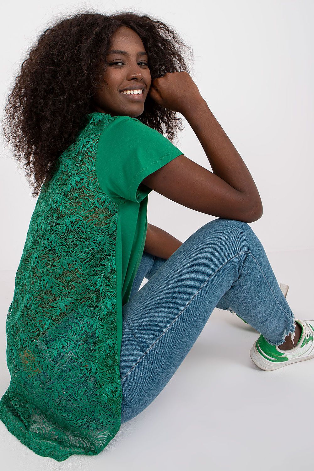 Chic view of the Elegant Short Sleeve Blouse with Lace Back and Cheese Neckline, highlighting intricate lace detailing, model sitting gracefully.