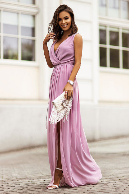 Dolores Chiffon Maxi Dress by IVON - Stunning side view of a model in a light pink maxi dress featuring an adjustable waist, ideal for summer outings.