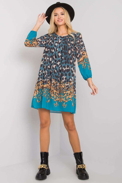 Luxurious Och Bella Loose-Fitting Daydress with 3/4 Sleeves and Rounded Neckline, styled with a black hat and chunky boots, featuring an elegant leopard print design.