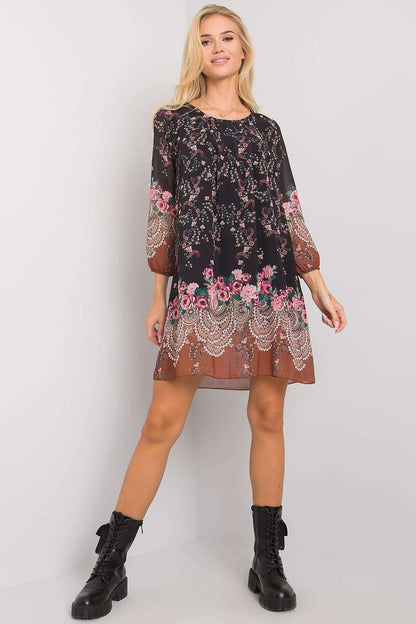 Luxurious Och Bella Loose-Fitting Daydress with 3/4 Sleeves and Rounded Neckline, epitomising luxury with its floral adornments on a chic black background, complemented by fashionable black lace-up boots.