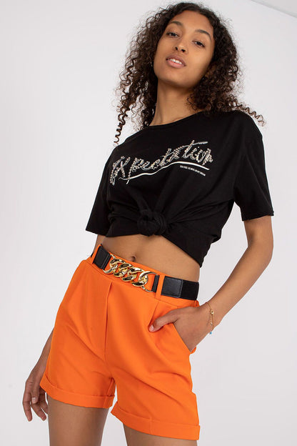 Chic model wearing Luxury Women's Elastic Waistband Shorts With Slip Pockets and Decorative Belt By Italy Moda, paired with a stylish black graphic t-shirt and a statement belt.
